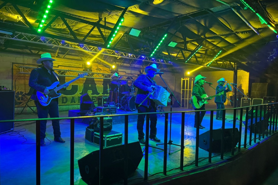 Musicians playing on stage in a spacious building, highlighting a popular attraction in the Rio Grande Valley.