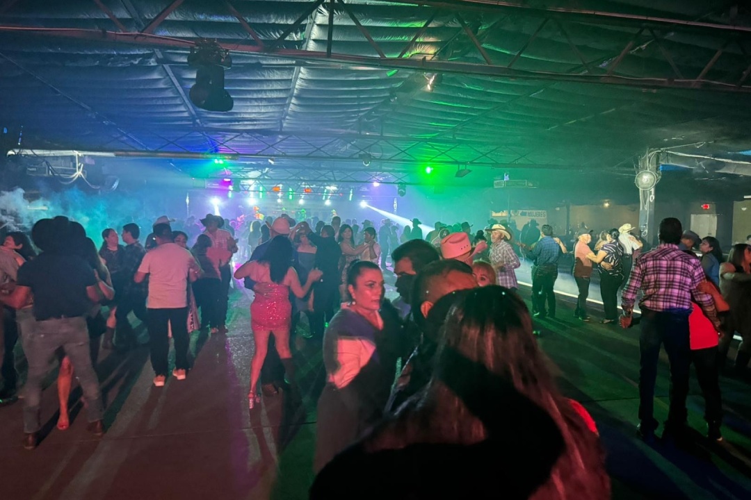 A bustling dance floor with numerous people dancing energetically, showcasing the vibrant nightlife of the Rio Grande Valley.